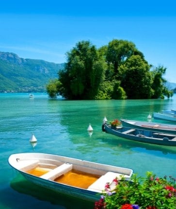 Small boats are docked on a lake in switzerland.