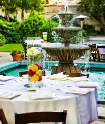 A table set up in front of a fountain.