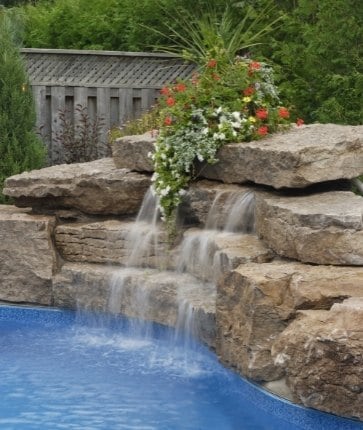 A pool with a waterfall in the middle of it.