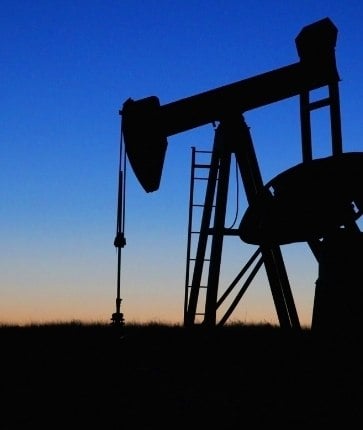 A silhouette of an oil pump at dusk.