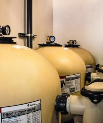 A group of sand filters in a room.