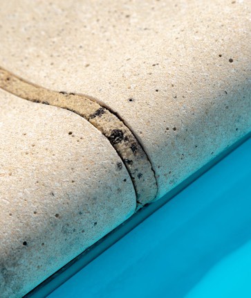 A close up of a concrete pool coping.
