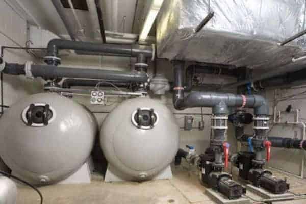 A room with two large tanks and pipes.